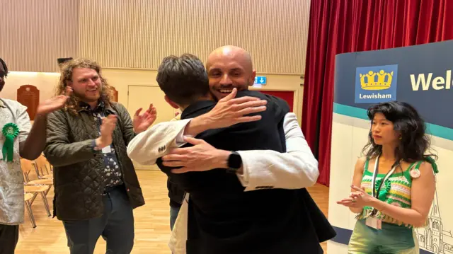 Liam Shrivastava, newly elected Green mayor, hugs a man.
