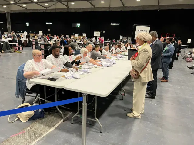 People sat a tables counting the results in Coventry.