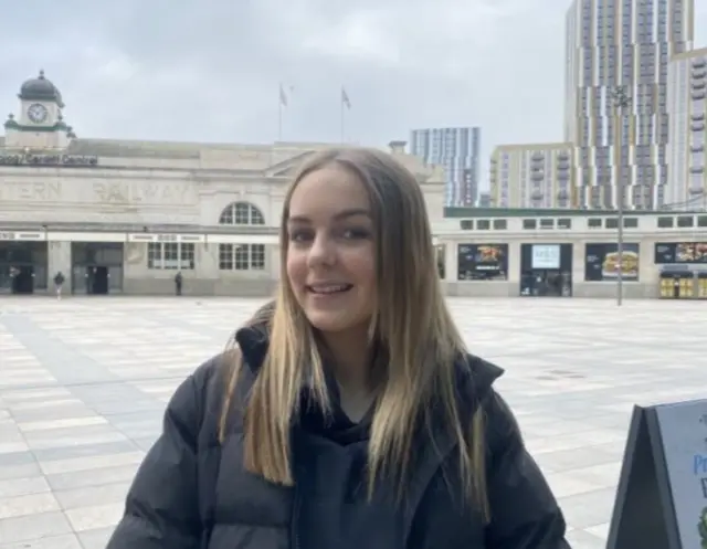 A girl smiles at the camera