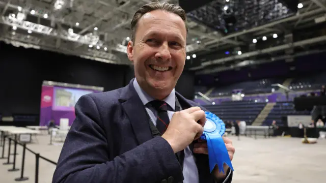 Russell Findlay pinning on a rosette