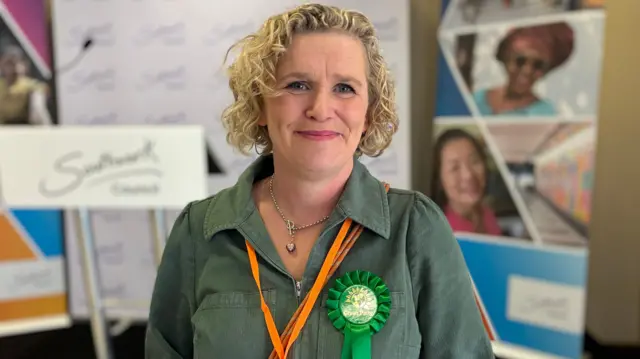 Claire Sheppard wearing a Green Party rosette