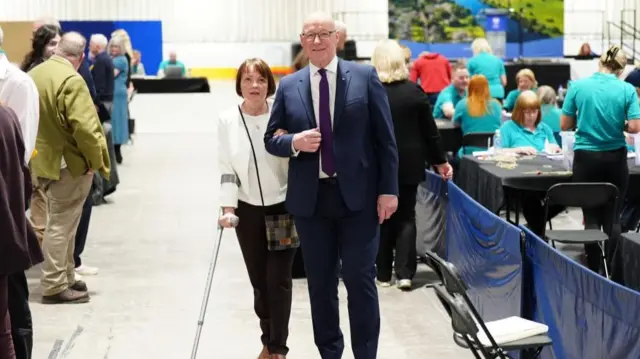First Minister and SNP leader John Swinney and his wife Elizabeth arrive at the counting centre for the 2026 Holyrood elections, at Dewars Centre in Perth