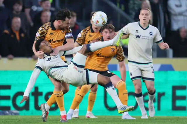 Millwall's Thierno Ballo attempts an acrobatic shot on goal under pressure from Hull City's Lewie Coyle