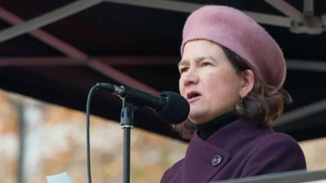 MP Catherine West pictured in 2018 wearing a pink beret and purple coat