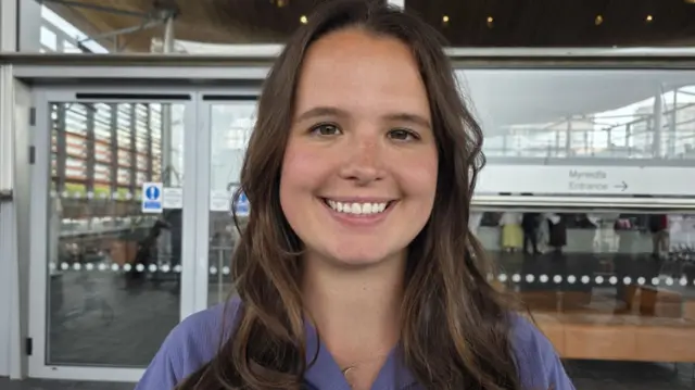 A smiling woman looking at the camera.