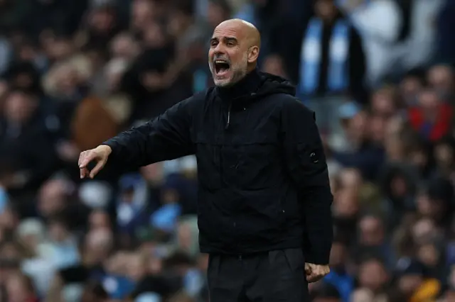 manager Pep Guardiola gestures on the touchline