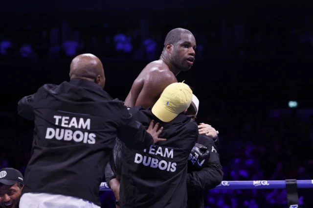 Daniel Dubois is lifted up by his team