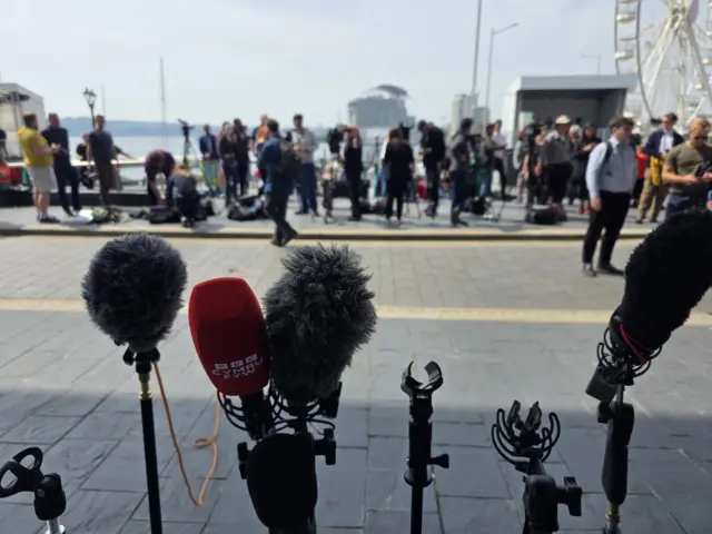 A set of microphones in front of a crowd