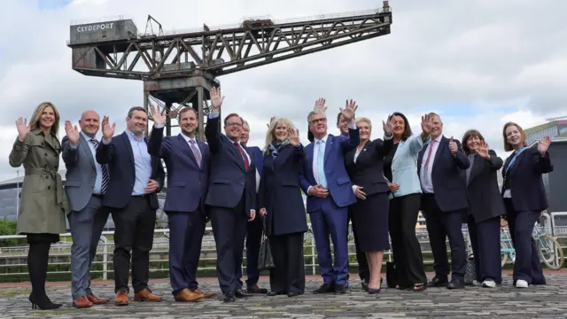 Elected Reform candidates waving at the camera during a photocall