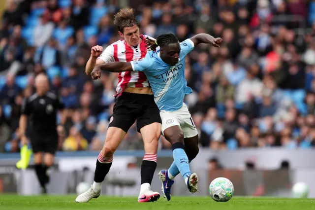 Jeremy Doku (right) and Brentford's Yehor Yarmolyuk battle for the ball
