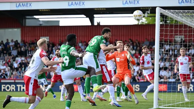 Kyle Wootton heads over