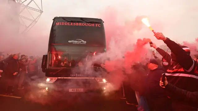 Middlesbrough bus arrives to a sea of fans and red smoke from flares