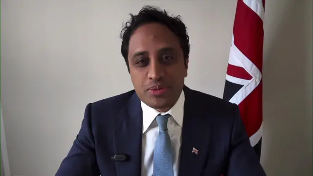 Reform UK's home affairs spokesperson Zia Yusuf speaks to BBC Breakfast, wearing suit and tie with Union Jack flag in background