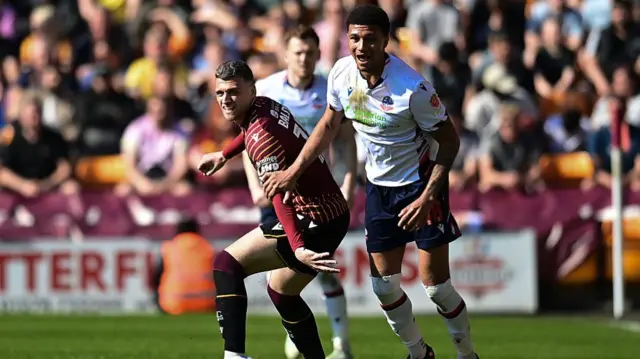 Bradford City's Aden Baldwin vies for possession with Bolton Wanderers' Mason Burstow