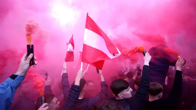 Red and white flags are flown with flares outside Middlesbrough's Riverside Stadium