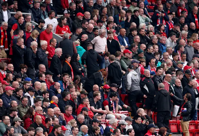 Fans of Liverpool leave the stadium during the Premier League match