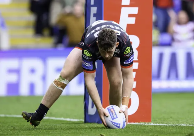 Jack Farrimond scores a try for Wigan against St Helens