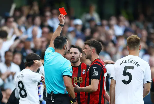 Ryan Christie is shown a red card by referee Andy Madley