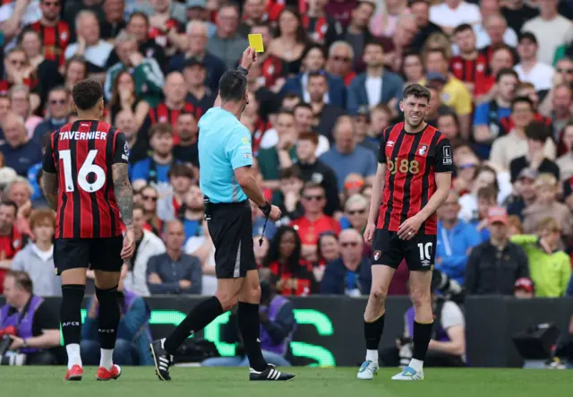 Ryan Christie is shown a yellow card by referee Andy Madley