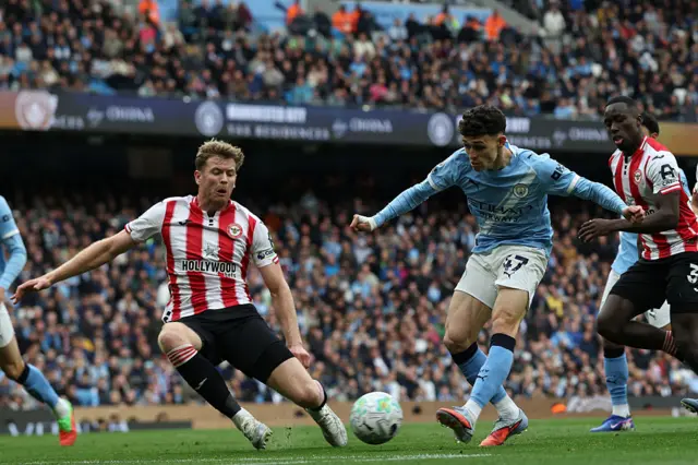 Phil Foden (R) shoots but fails to score during the English Premier League football match between Manchester City and Brentford