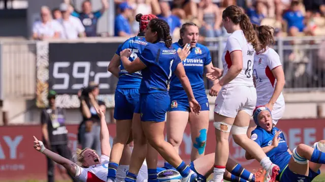 Marlie Packer (bottom left) raises both arms in the air to celebrate a try