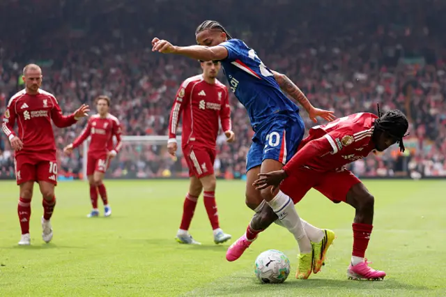 Joao Pedro of Chelsea is challenged by Jeremie Frimpong of Liverpool
