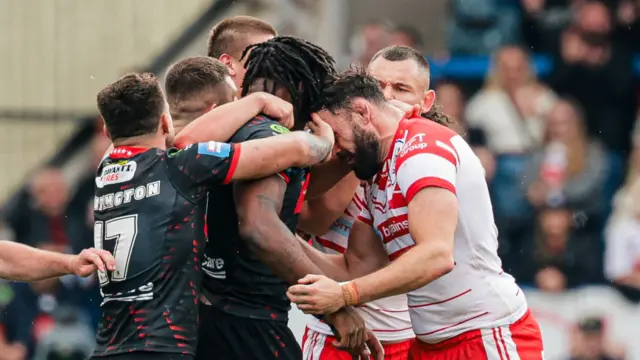 St Helens' Alex Walmsley and Wigan's Junior Nsemba push their heads into each other