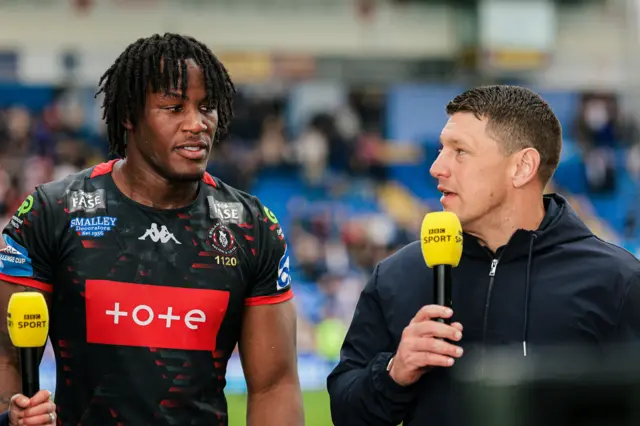 Wigan head coach Matt Peet (right) and Junior Nsemba talk to the BBC after the win over St Helens