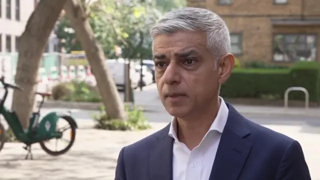 Sadiq Khan standing on a street