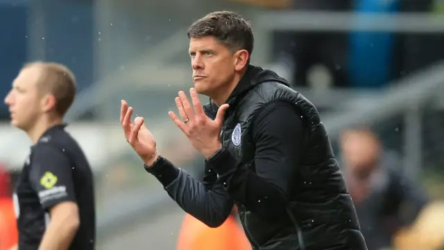 Alex Revell holds his hands out and looks stern on the Stevenage touchline