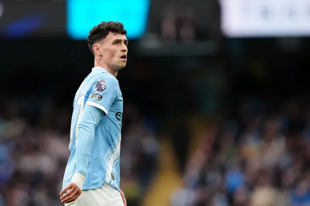 Phil Foden looks on