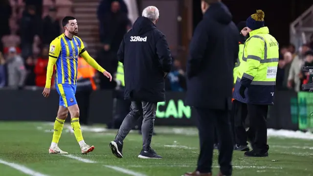 Finn Azaz walks off the pitch at the Riverside