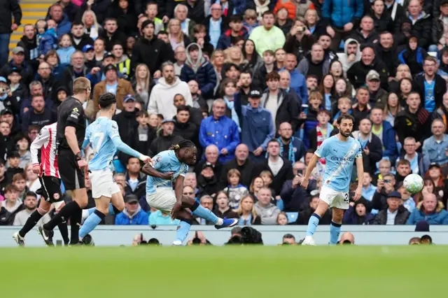Jeremy Doku (centre) scores their side's first goal