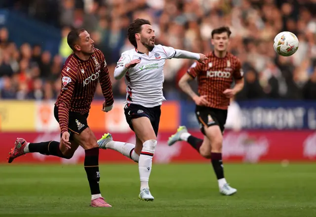 Josh Sheehan of Bolton Wanderers chases after the ball while under pressure from Antoni Sarcevic of Bradford City