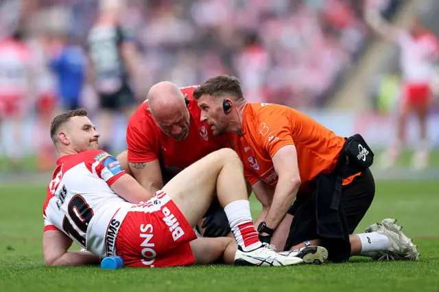 St Helens' Matty Lees receives treatment after picking up an early injury