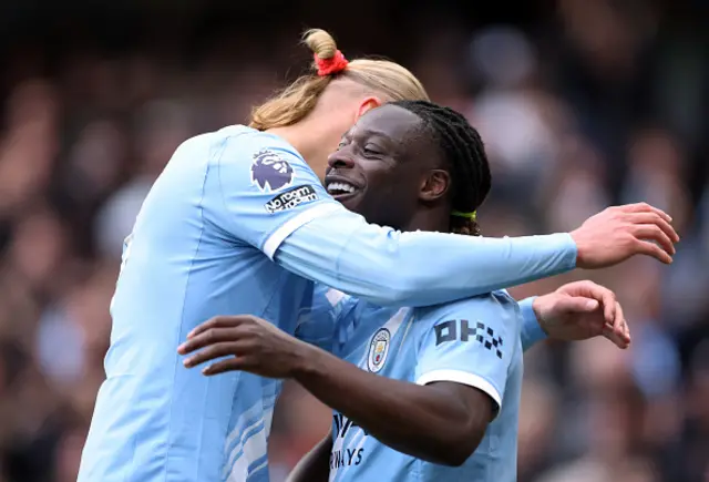 Jeremy Doku of Manchester City celebrates scoring his team's first goal with teammate Erling Haaland