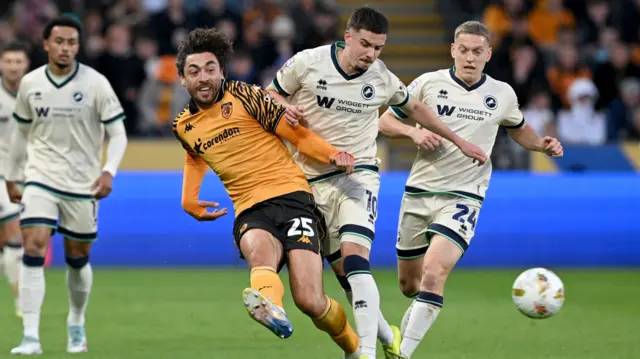 Matt Crooks of Hull and Camiel Neghli in action for Millwall