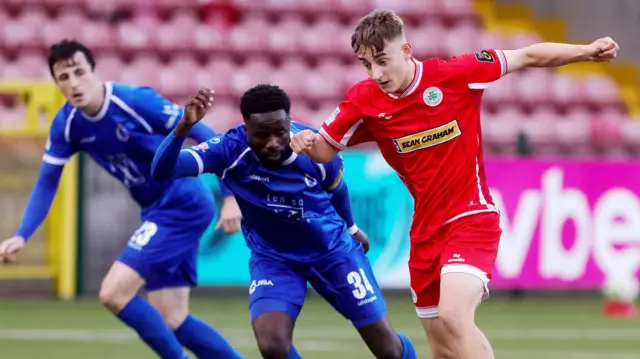 Cliftonville’s Keevan Hawthorn with Dungannon’s Gael Bigirimana