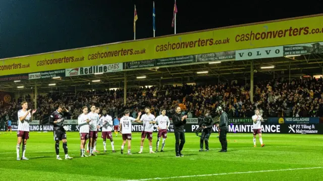 Hearts players applaud away end