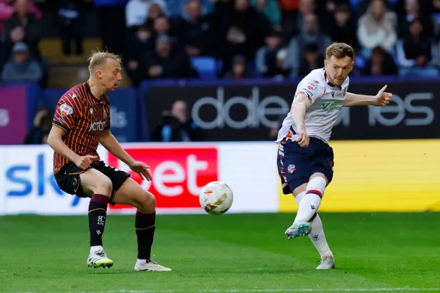 George Johnston of Bolton Wanderers clears the ball