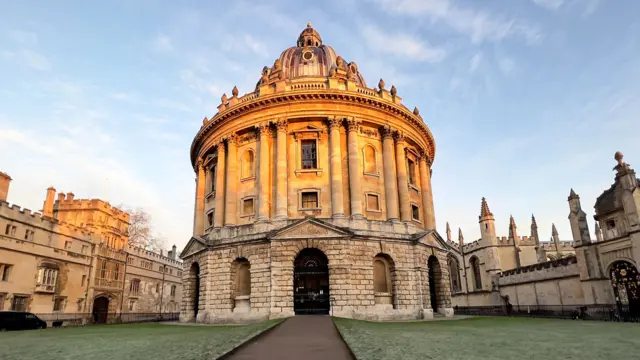 Radcliffe Camera, Oxford, a large historic building that is circular and surrounded by grass.