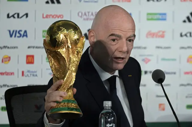 Gianni Infantino holding the World Cup trophy
