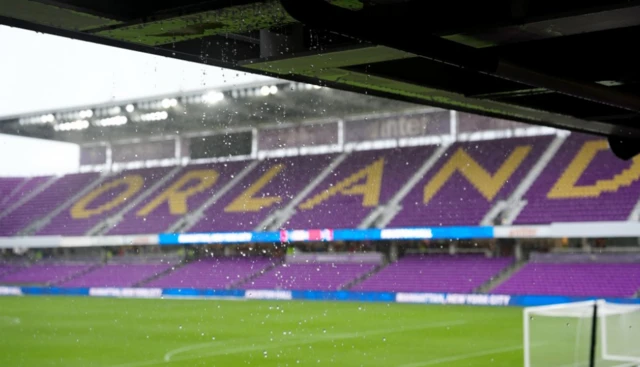 Rain falls inside the stadium as a heavy thunderstorm in Orlando