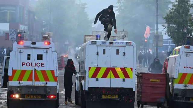 Protestors attack a police vehicle in Sandy Row in Belfast.