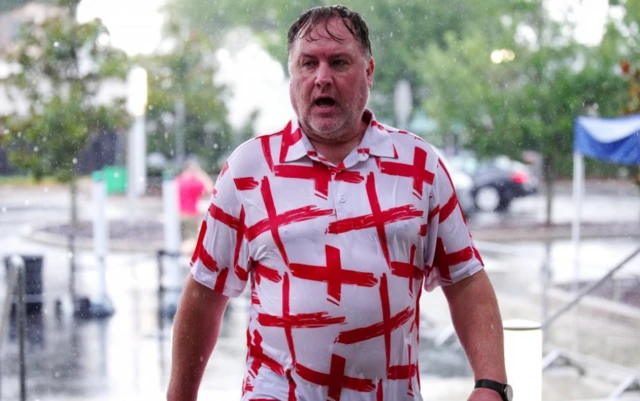 An England fan in the rain