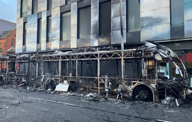 The burnt out frame of a bus.