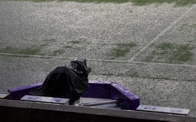 A general view of the pitch as heavy rain falls