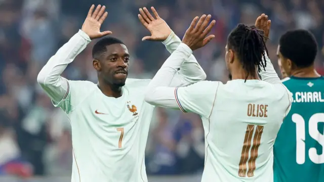 Michael Olise celebrates his goal with Ousmane Dembele