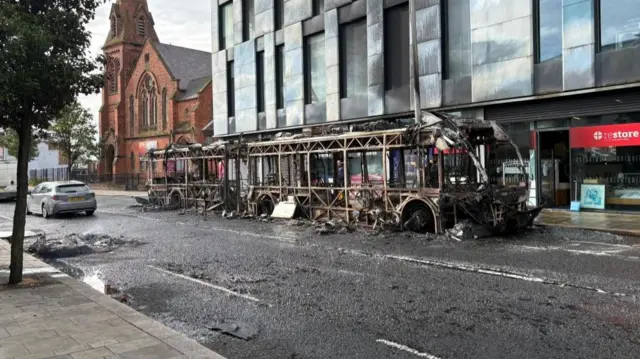 A burned-out Gilder bus on Newtownards Road in east Belfast, seen on Wednesday morning