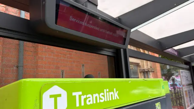 Red translink sign saying 'Services suspended until further notice'